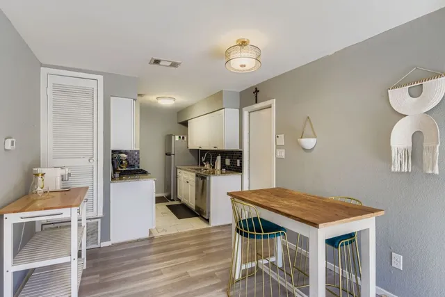 a kitchen with a table and chairs in it