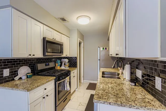 a kitchen with a sink stove and microwave