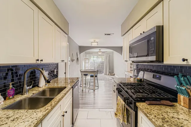 a kitchen with a stove a sink and a microwave