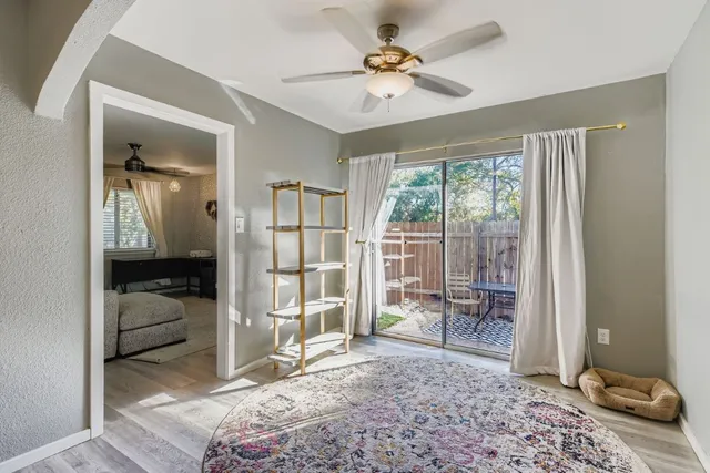 a bedroom with a bed and glass door