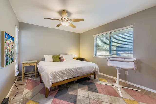 a bedroom with a bed and windows