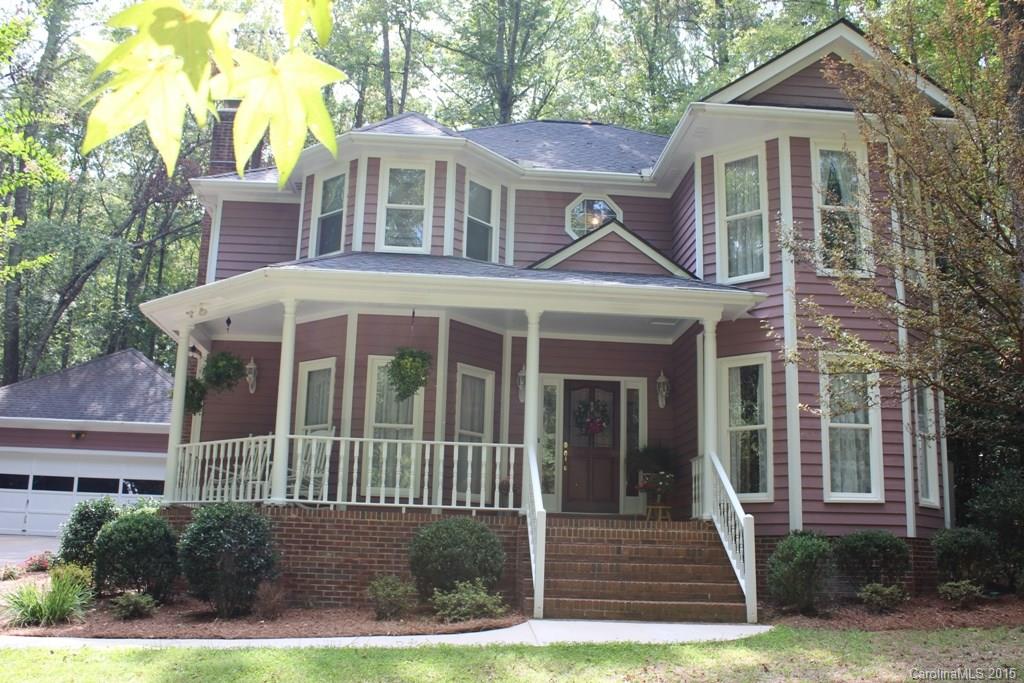 2717 Farmstead Lane, Unit 61 Fort Mill, SC 29708 - Photo 1 of 23 a view of a white house with a small yard and potted plants
