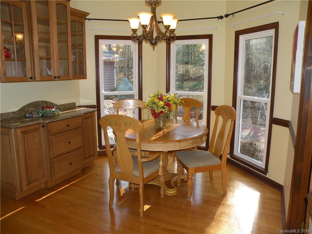 2717 Farmstead Lane, Unit 61 Fort Mill, SC 29708 - Photo 13 of 23 a view of a dining room with furniture a chandelier and wooden floor