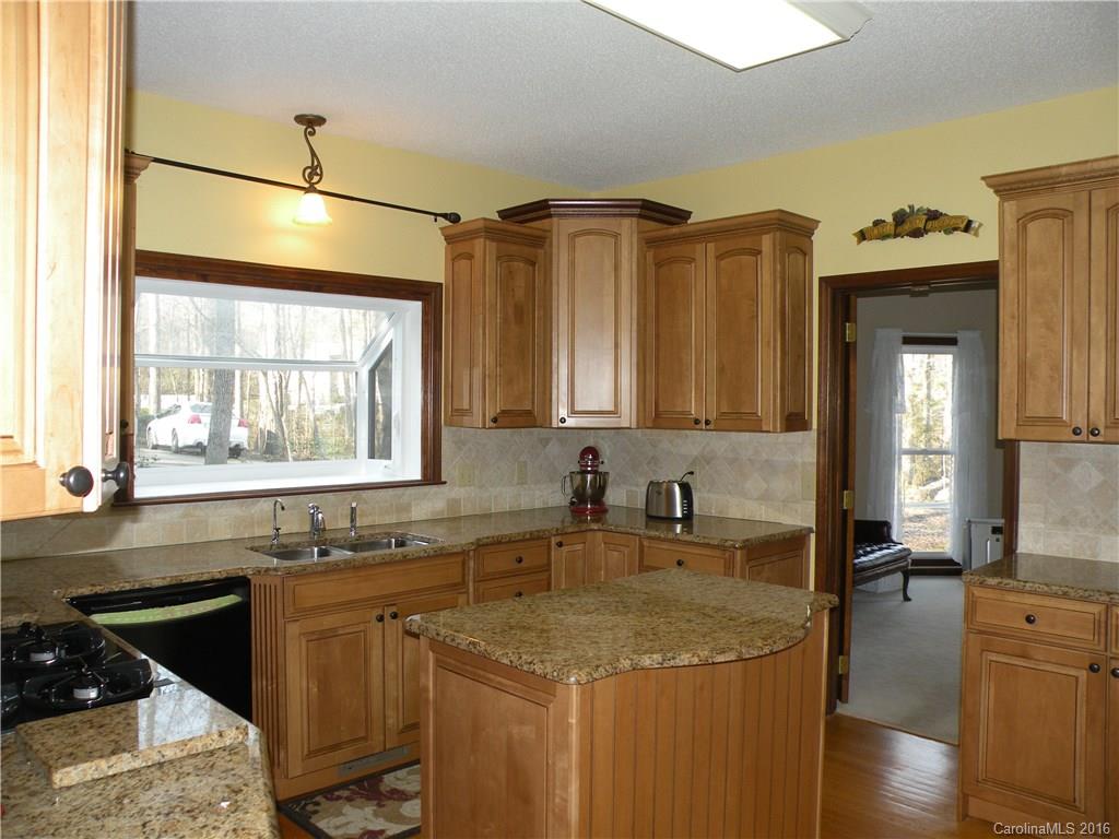 2717 Farmstead Lane, Unit 61 Fort Mill, SC 29708 - Photo 16 of 23 a kitchen with a sink stove and cabinets