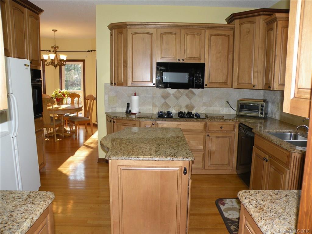 2717 Farmstead Lane, Unit 61 Fort Mill, SC 29708 - Photo 17 of 23 a kitchen with a sink stove and refrigerator