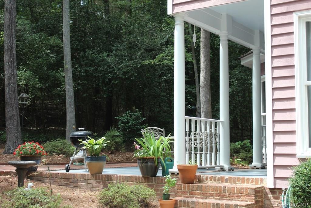 2717 Farmstead Lane, Unit 61 Fort Mill, SC 29708 - Photo 5 of 23 a view of a chair and table in the patio with potted plants