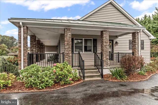 an aerial view of residential house with outdoor space and swimming pool