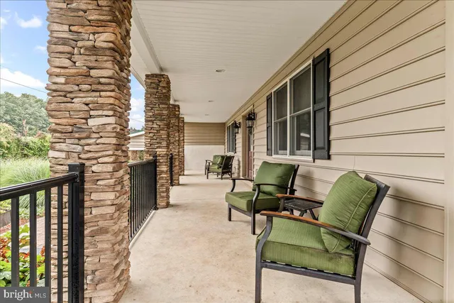 an aerial view of a house with a yard and lake view