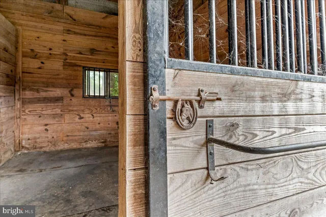 a view of a big room with wooden floor a kitchen space and a window