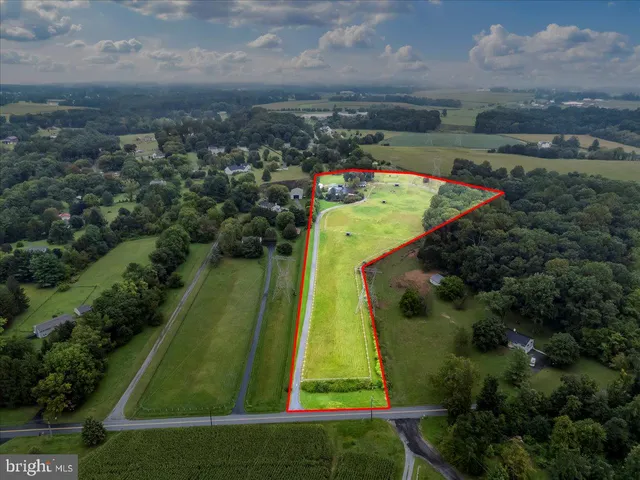 a kitchen with stainless steel appliances kitchen island granite countertop a refrigerator oven a sink dishwasher and a refrigerator with wooden floor