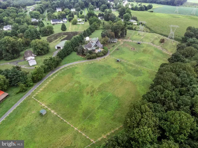 a kitchen with stainless steel appliances granite countertop a stove a refrigerator and a sink with wooden floors