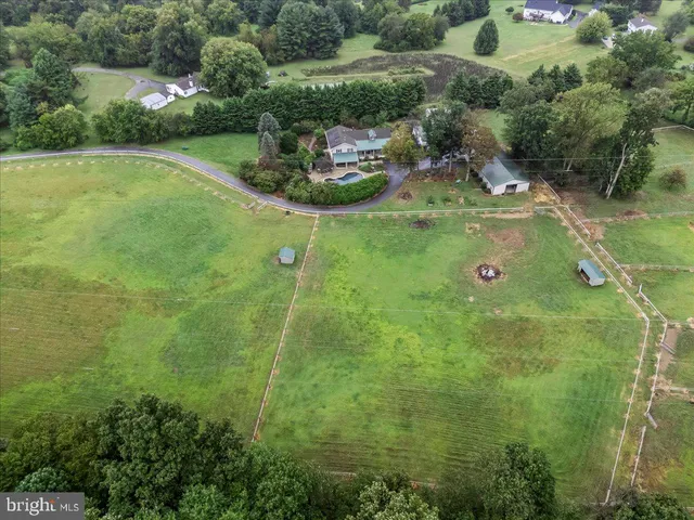 a large kitchen with stainless steel appliances granite countertop a stove a sink and a refrigerator