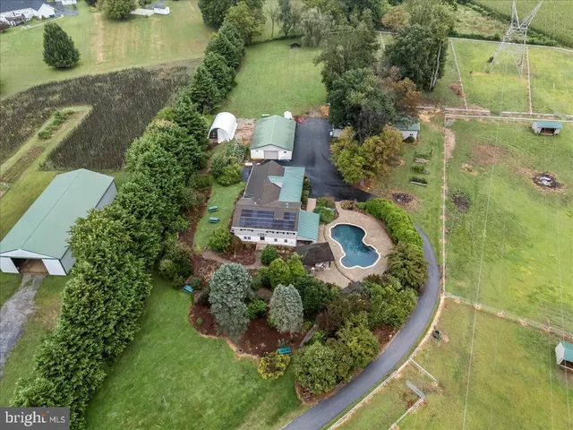 a large kitchen with stainless steel appliances kitchen island a large counter top and a wooden floors
