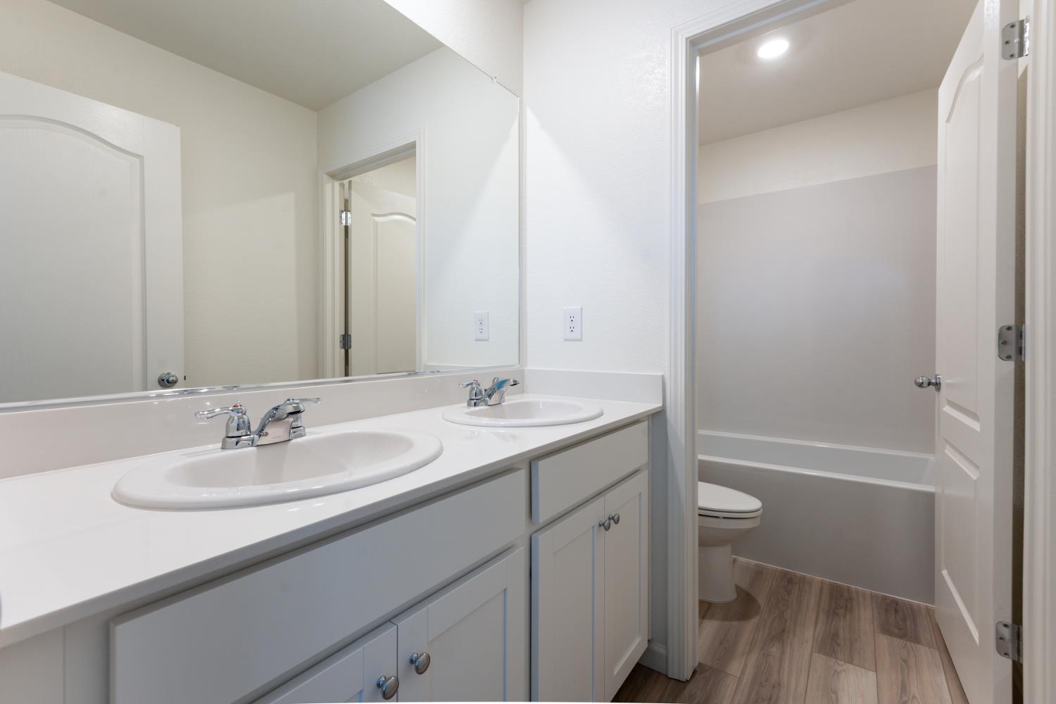 2259 Travis Court Newman, CA 95360 - Photo 15 of 17 a bathroom with a sink a toilet and shower
