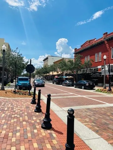 a view of a bench in the river next to a yard