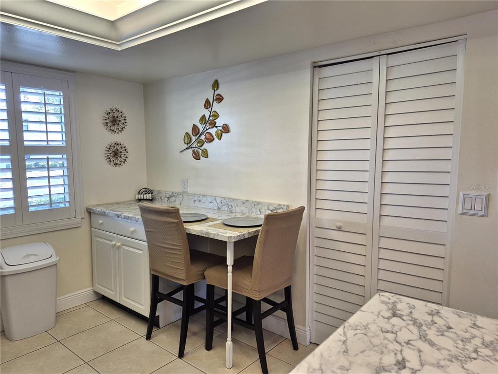107 Windward Place, Unit 107 Oldsmar, FL 34677 - Photo 17 of 34 a view of a dining room with a table and chairs