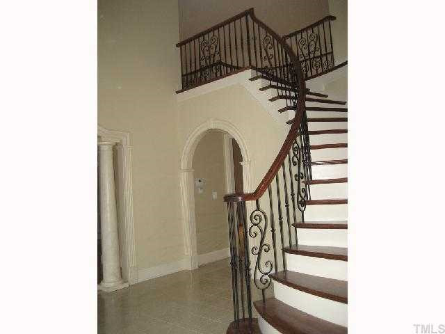 6301 Swallow Cove Lane Raleigh, NC 27614 - Photo 3 of 12 Two Story, dramatic Marble foyer entry with Tile Medallion; features a display niche; hand forged wrought iron adorns circular stairs in foyer & second floor balcony. Foyer