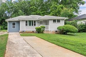 2756 Gresham Rd S East Atlanta, GA 30316 - Photo 6 of 32 a front view of a house with a yard and potted plants
