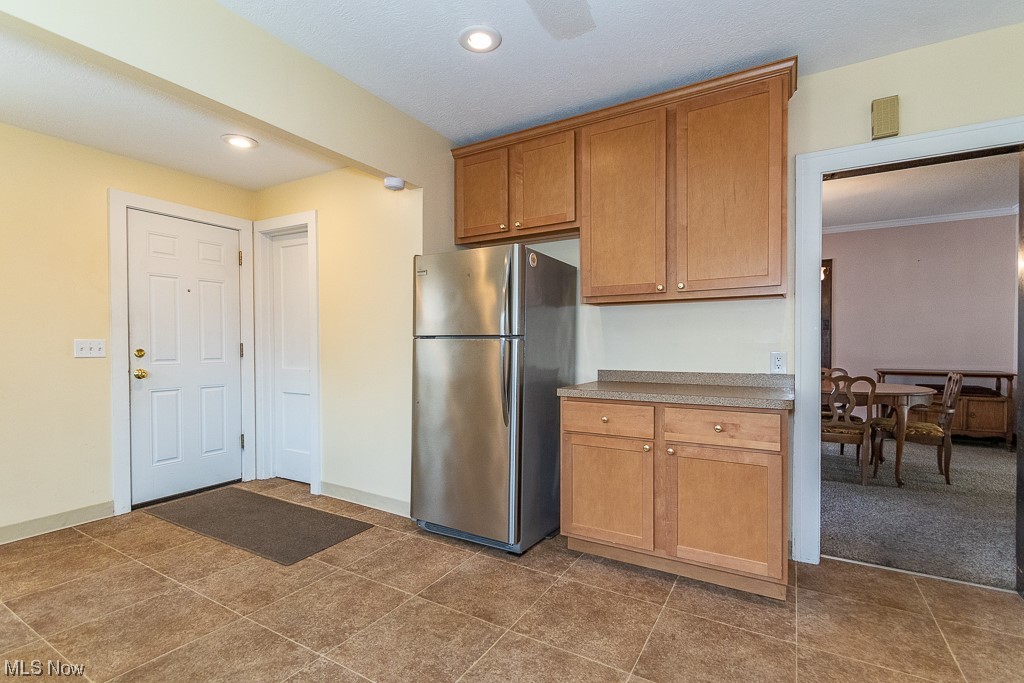29396 Detroit Road Westlake, OH 44145 - Photo 15 of 30 Kitchen featuring stainless steel fridge and dark tile flooring.