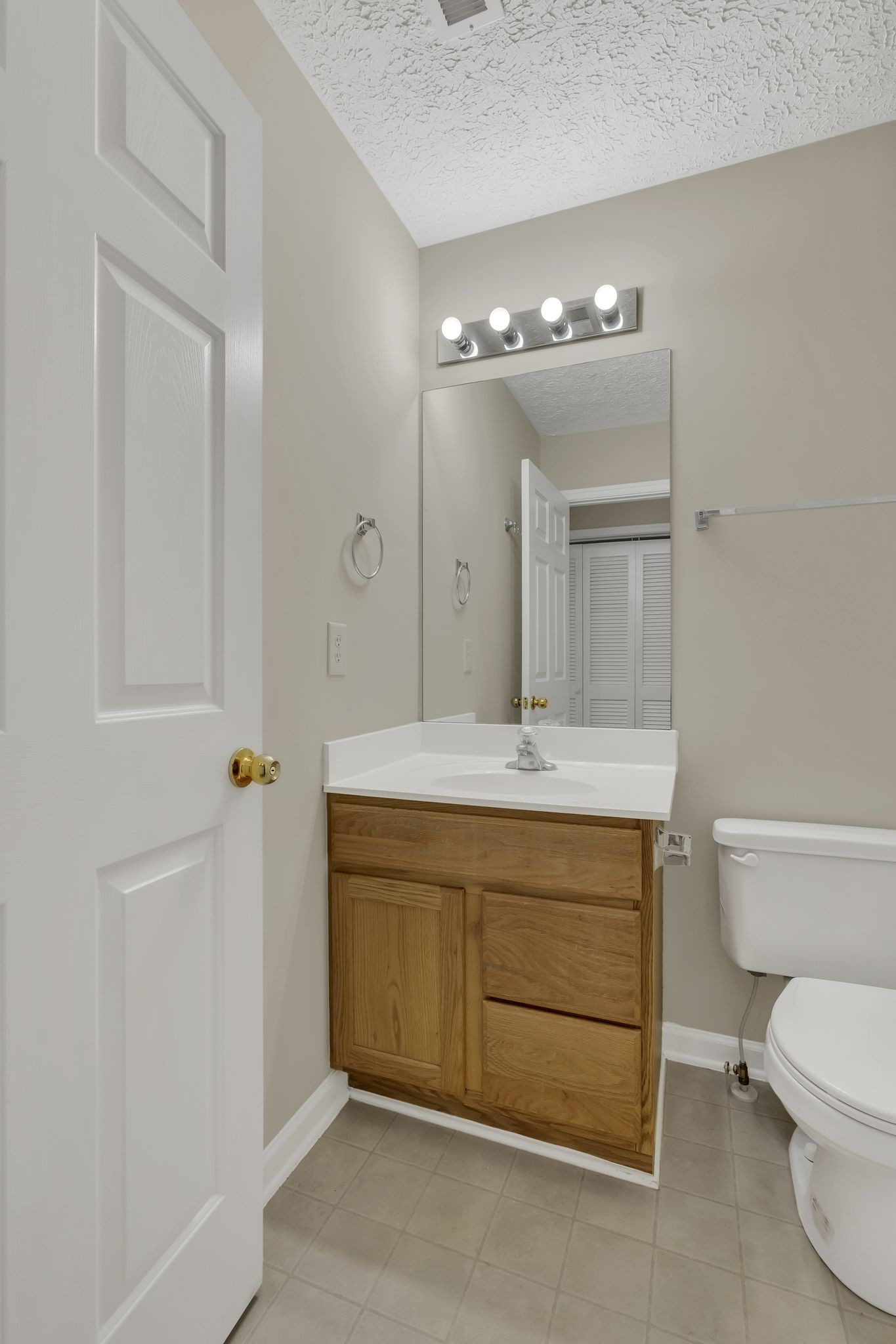 7714 Porter House Drive Nashville, TN 37211 - Photo 27 of 39 a bathroom with a granite countertop sink a toilet and mirror
