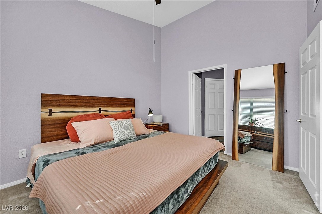 10550 West Alexander Road, Unit 2065 Las Vegas, NV 89129 - Photo 14 of 27 Bedroom with light carpet, a high ceiling, and ceiling fan