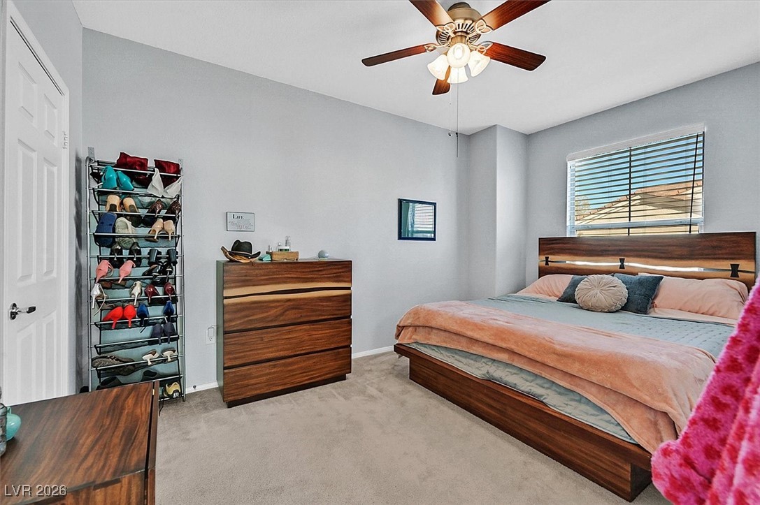10550 West Alexander Road, Unit 2065 Las Vegas, NV 89129 - Photo 19 of 27 Carpeted bedroom featuring a ceiling fan and baseboards