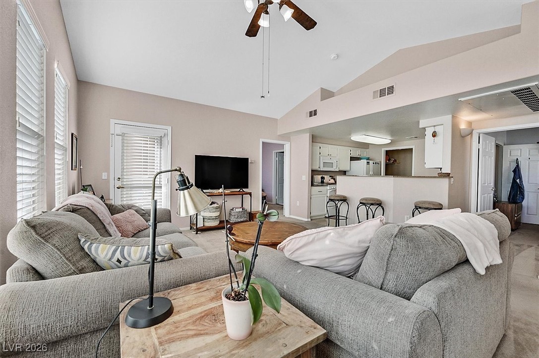 10550 West Alexander Road, Unit 2065 Las Vegas, NV 89129 - Photo 6 of 27 Living room featuring ceiling fan and high vaulted ceiling