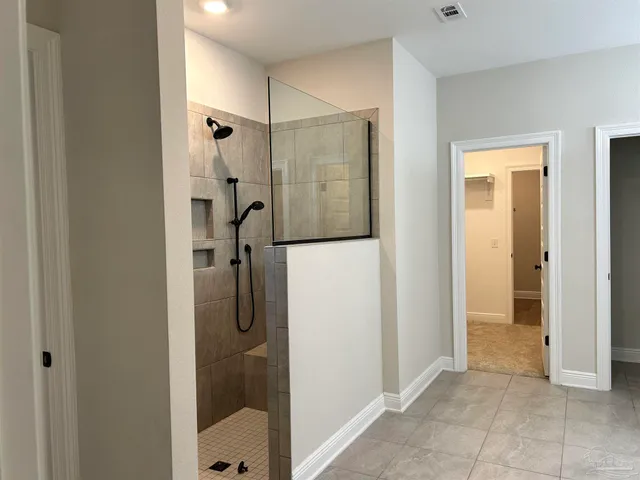 a bathroom with a granite countertop toilet sink and mirror