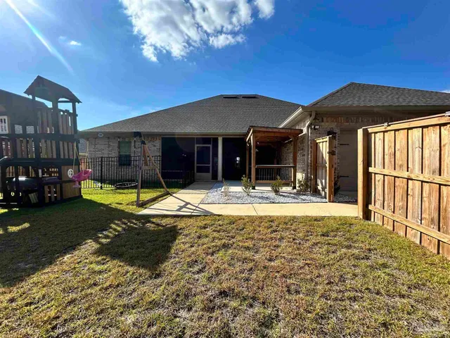 a view of swimming pool in the backyard of house along with seating space