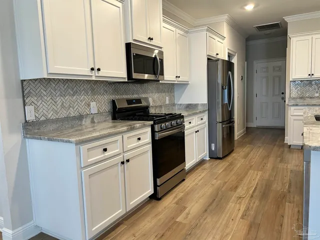 a kitchen with stainless steel appliances and wooden cabinets