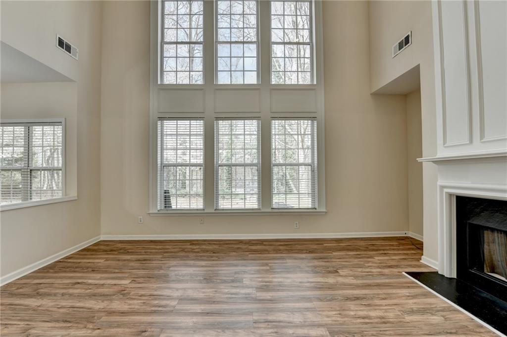 100 Hawnley Trc Northwest Suwanee, GA 30024 - Photo 15 of 58 a view of an empty room with wooden floor and a window