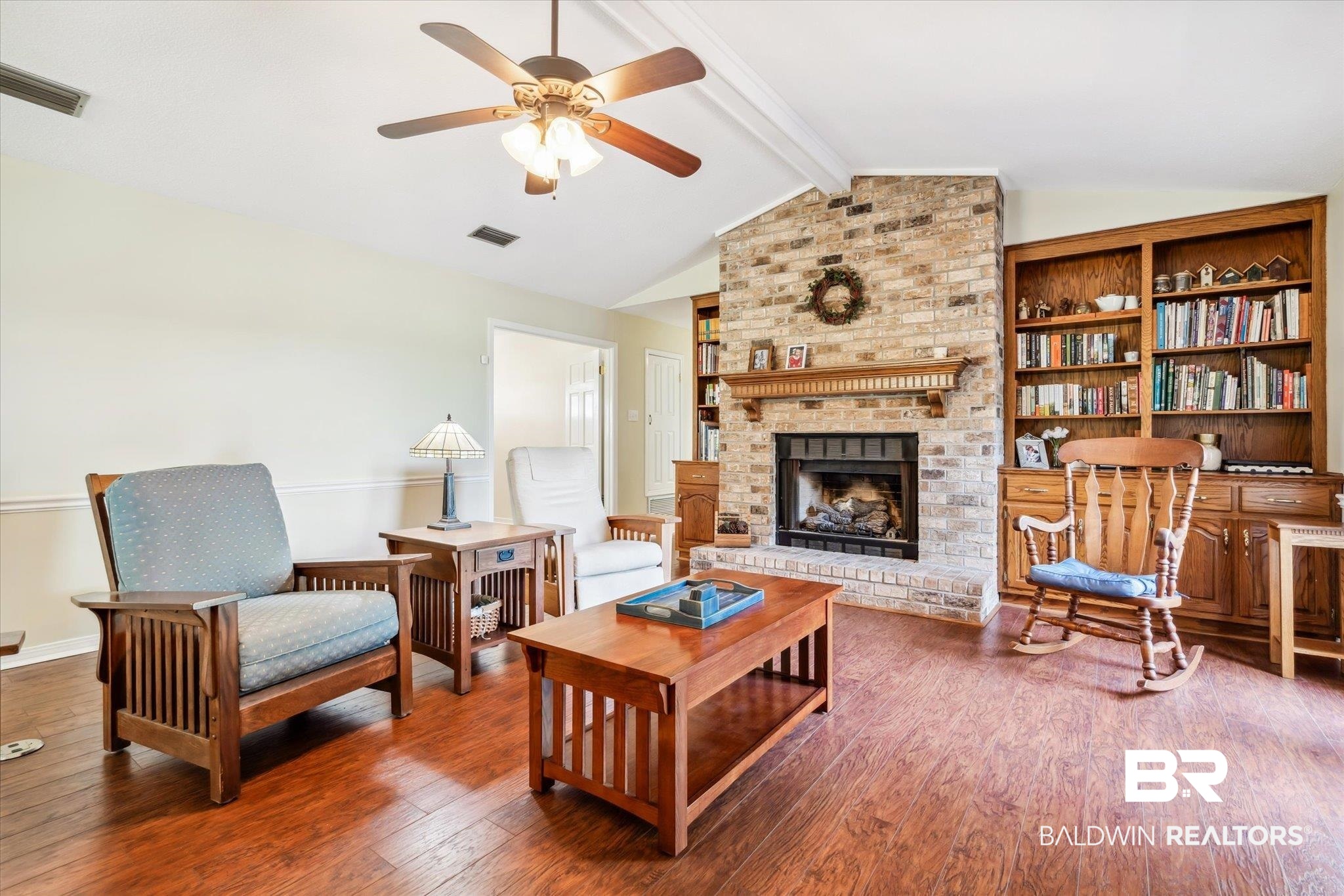8710 Three Notch Road Mobile, AL 36619 - Photo 5 of 30 Living room featuring vaulted ceiling with beams, a brick fireplace, ceiling fan, hardwood / wood-style floors, and brick wall