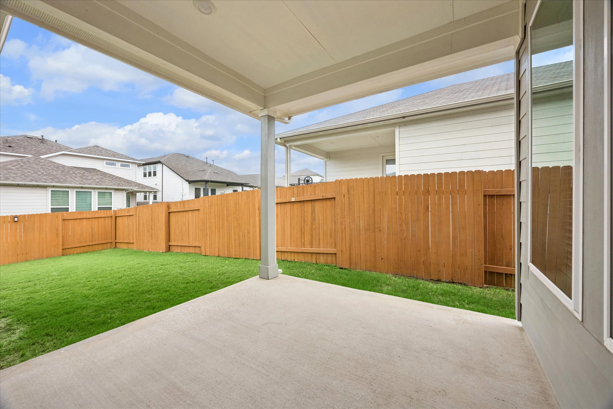 6407 Rounded Pebble Lane Buda, TX 78610 - Photo 28 of 32 A private, fenced backyard awaits with a covered concrete patio for outdoor enjoyment.