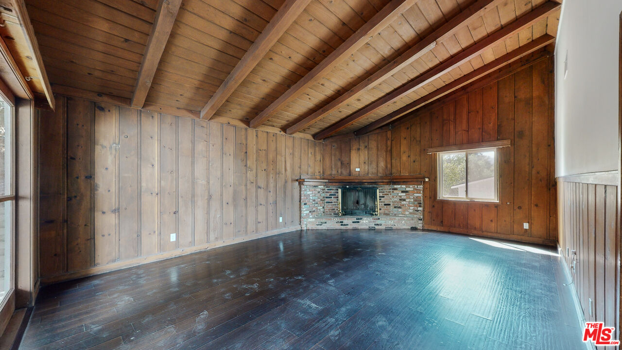 7865 Denivelle Road Sunland, CA 91040 - Photo 11 of 54 an empty room with wooden floor and windows