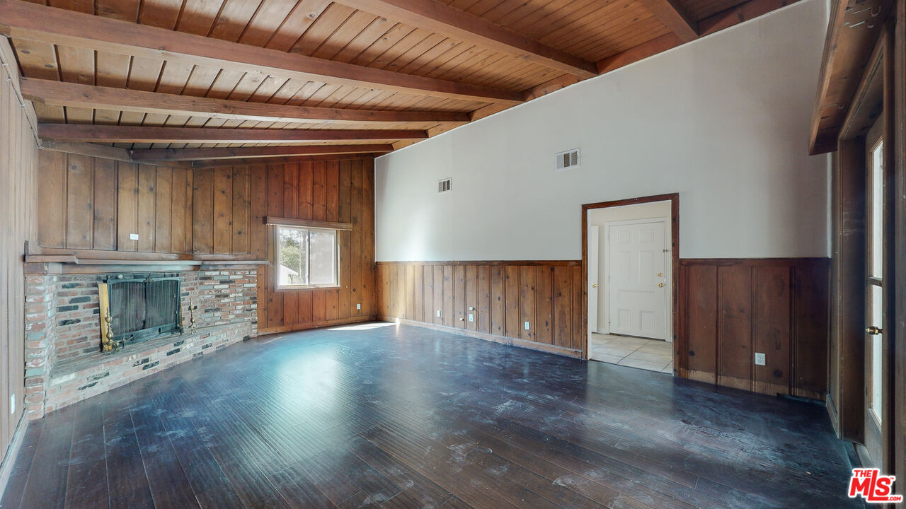 7865 Denivelle Road Sunland, CA 91040 - Photo 12 of 54 a view of an empty room with wooden floor and a fireplace