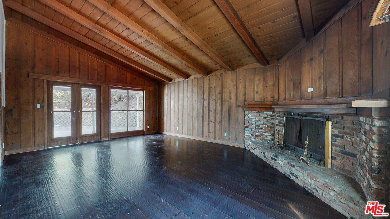 7865 Denivelle Road Sunland, CA 91040 - Photo 14 of 54 a view of an empty room with wooden floor and a window