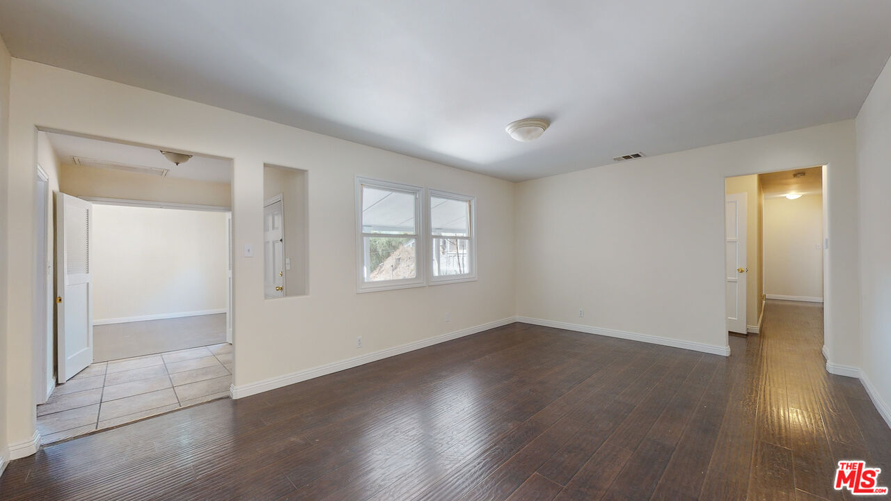 7865 Denivelle Road Sunland, CA 91040 - Photo 16 of 54 an empty room with wooden floor and windows
