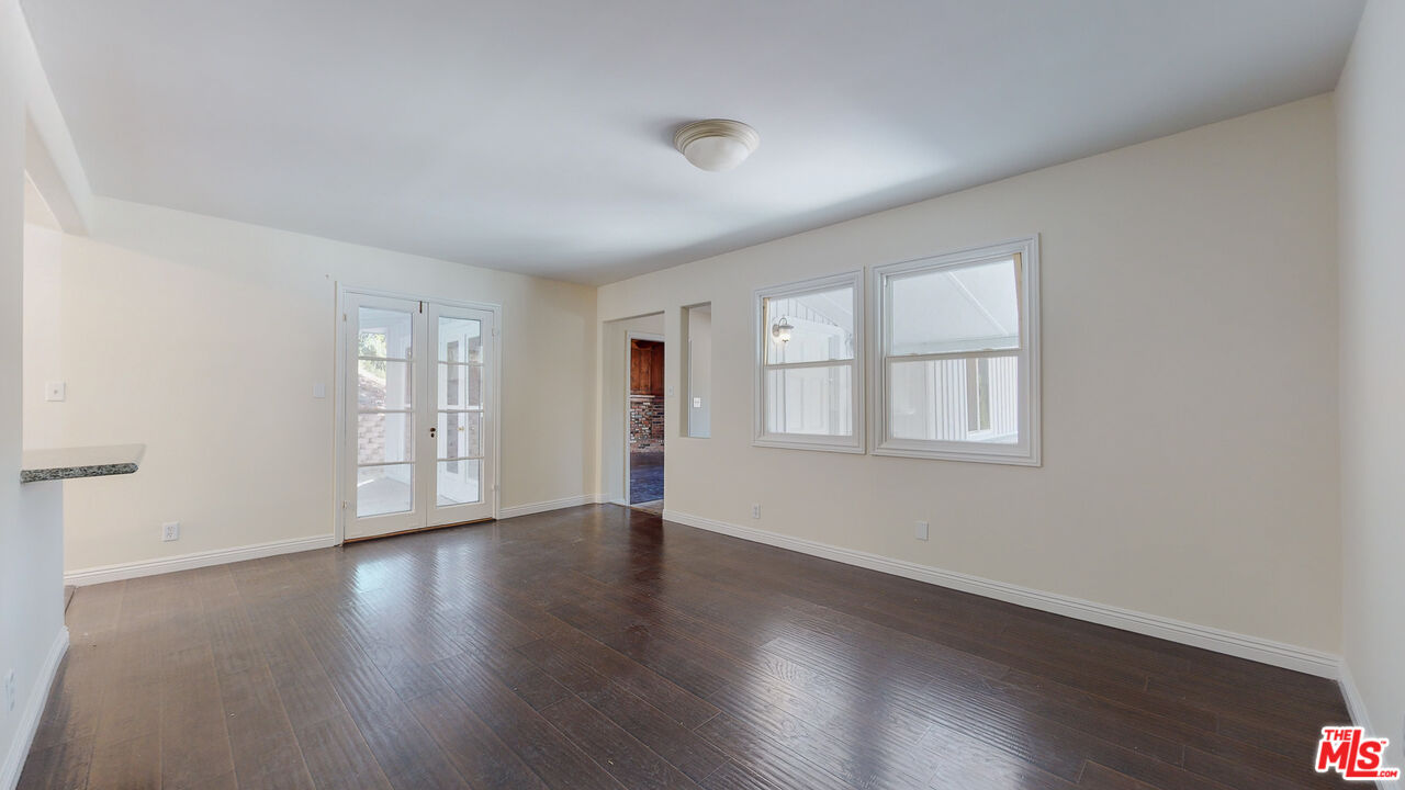 7865 Denivelle Road Sunland, CA 91040 - Photo 18 of 54 a view of an empty room with wooden floor and window