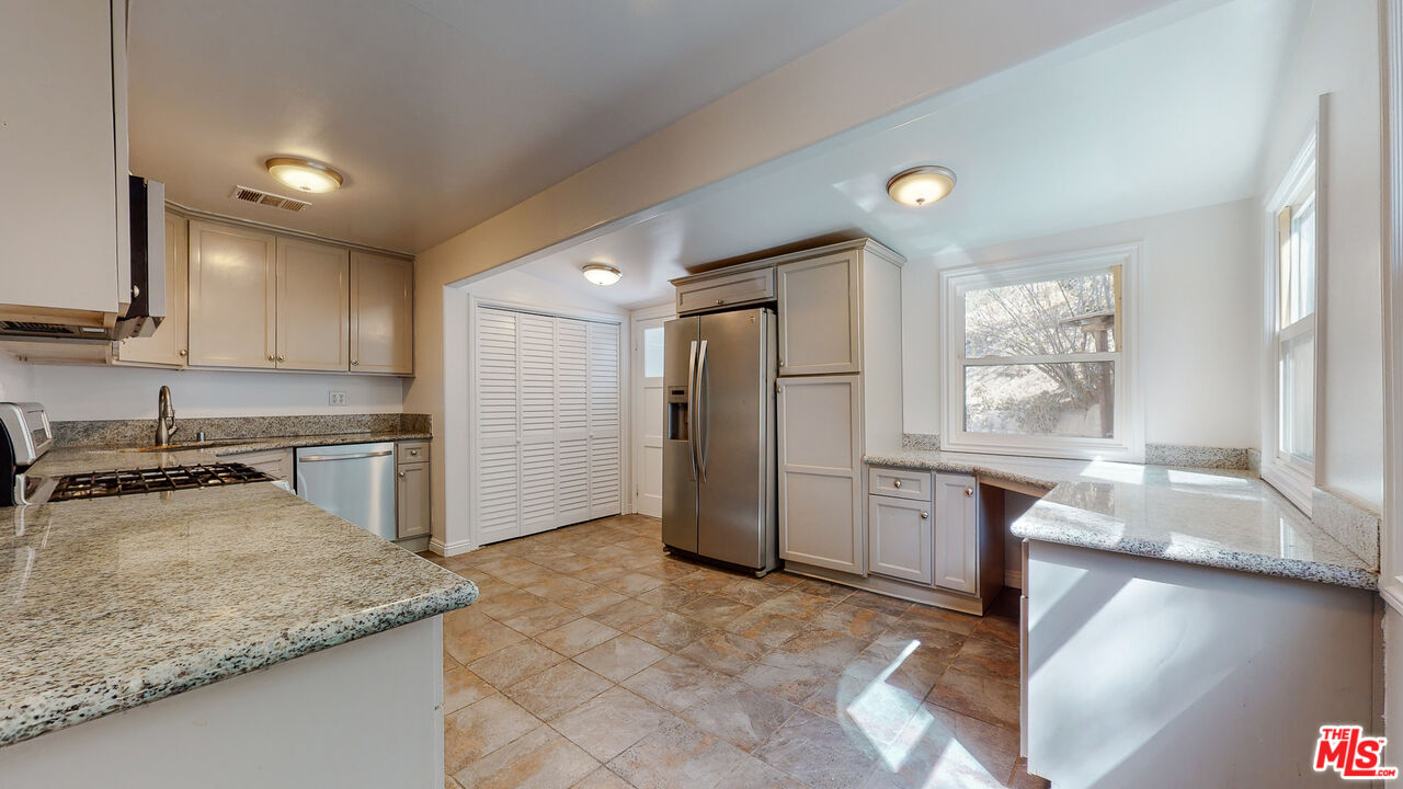 7865 Denivelle Road Sunland, CA 91040 - Photo 19 of 54 a kitchen with a sink stove and refrigerator