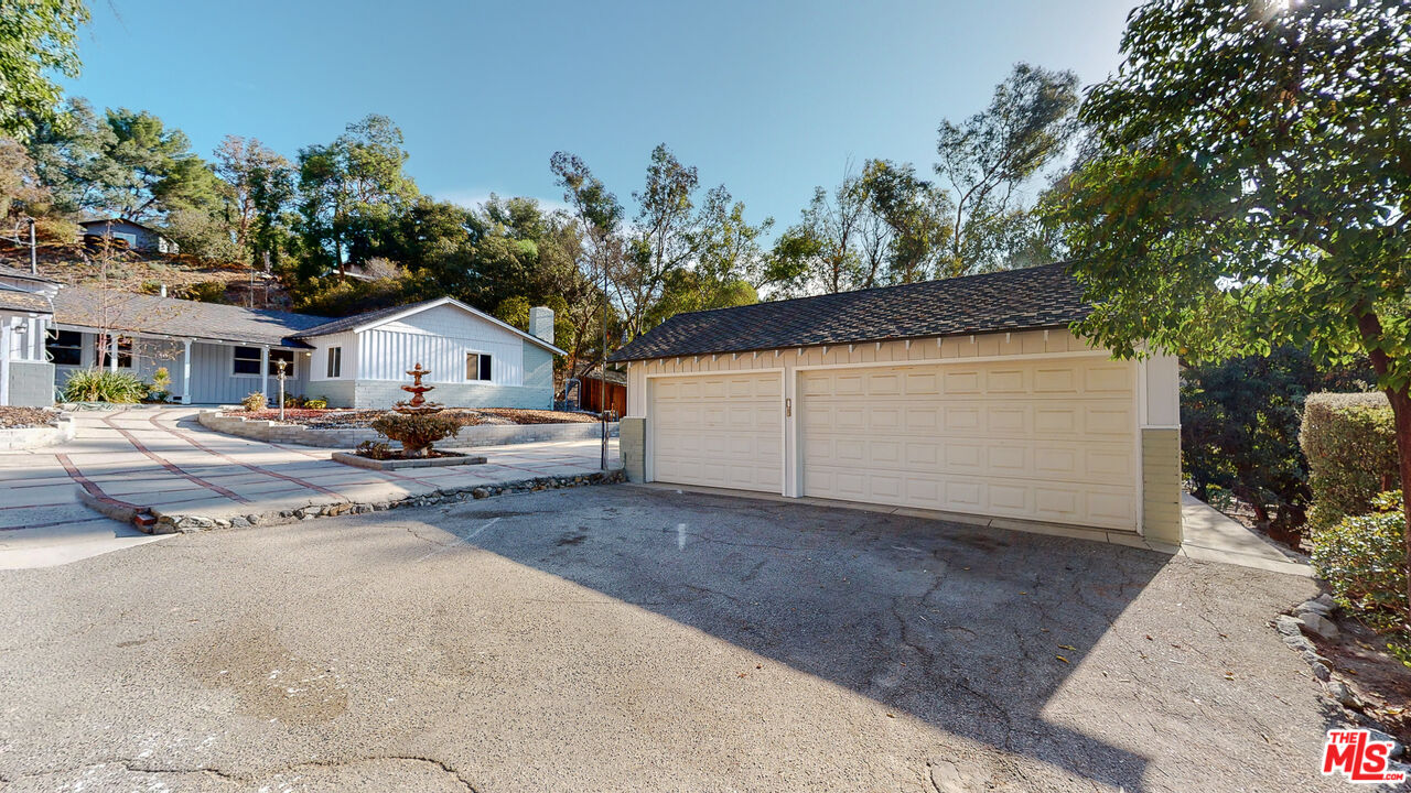 7865 Denivelle Road Sunland, CA 91040 - Photo 3 of 54 a view of white house with a yard and garage