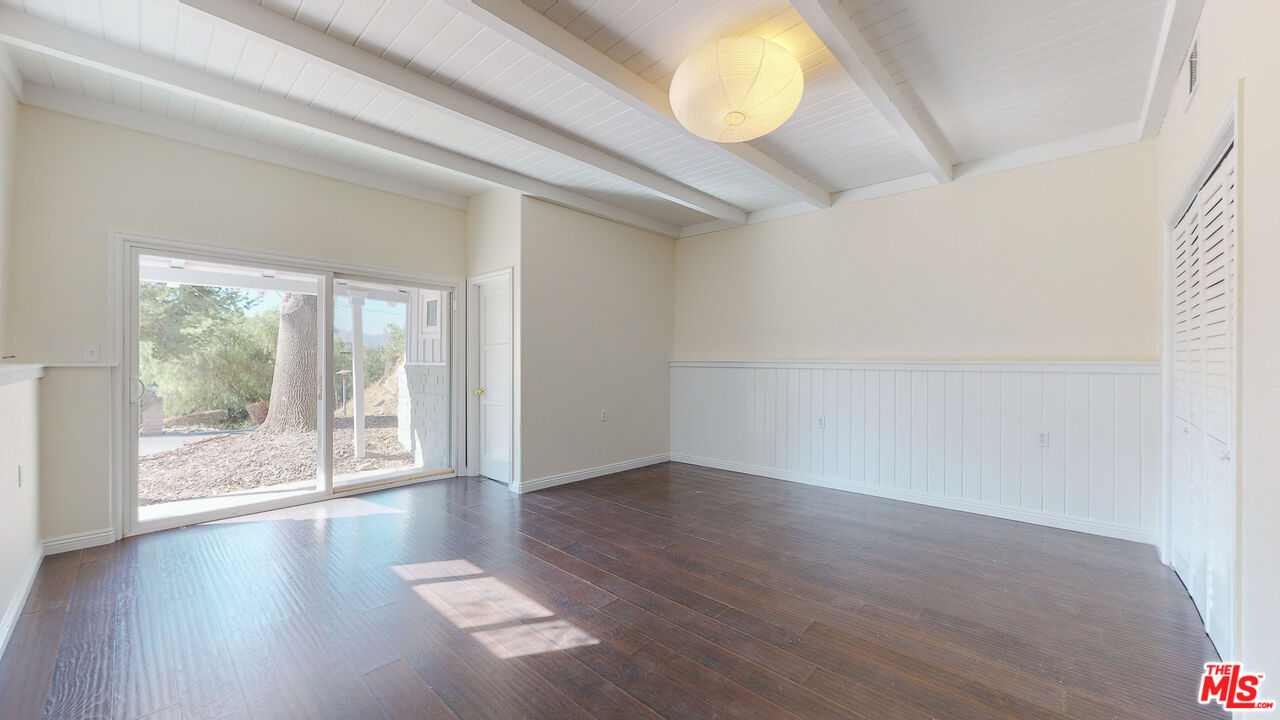 7865 Denivelle Road Sunland, CA 91040 - Photo 25 of 54 a view of an empty room with wooden floor and a window