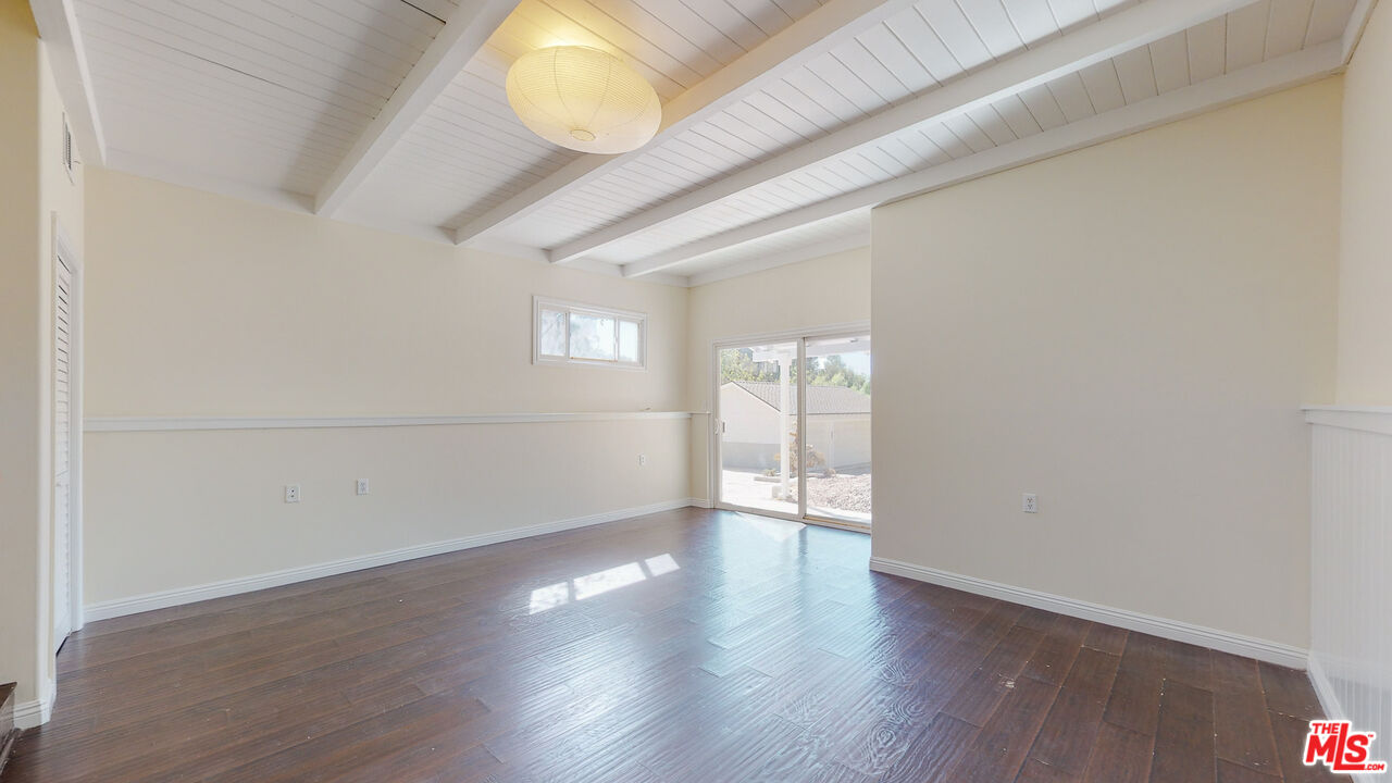 7865 Denivelle Road Sunland, CA 91040 - Photo 26 of 54 a view of an empty room with wooden floor and a window