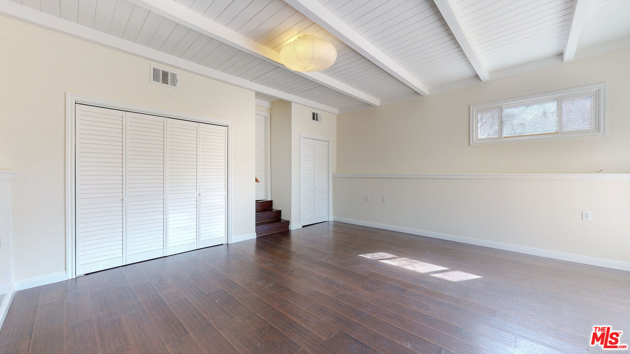 7865 Denivelle Road Sunland, CA 91040 - Photo 27 of 54 a view of an empty room with wooden floor and a window