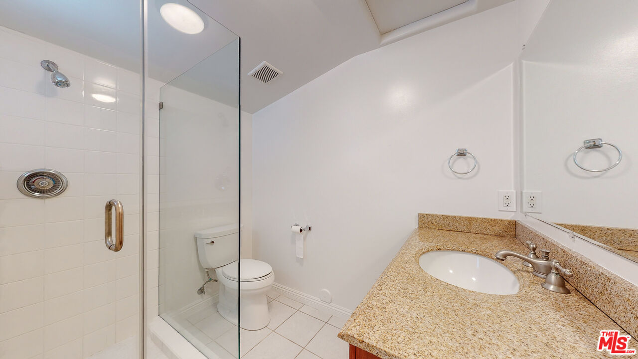 7865 Denivelle Road Sunland, CA 91040 - Photo 29 of 54 a bathroom with a granite countertop sink mirror vanity and toilet