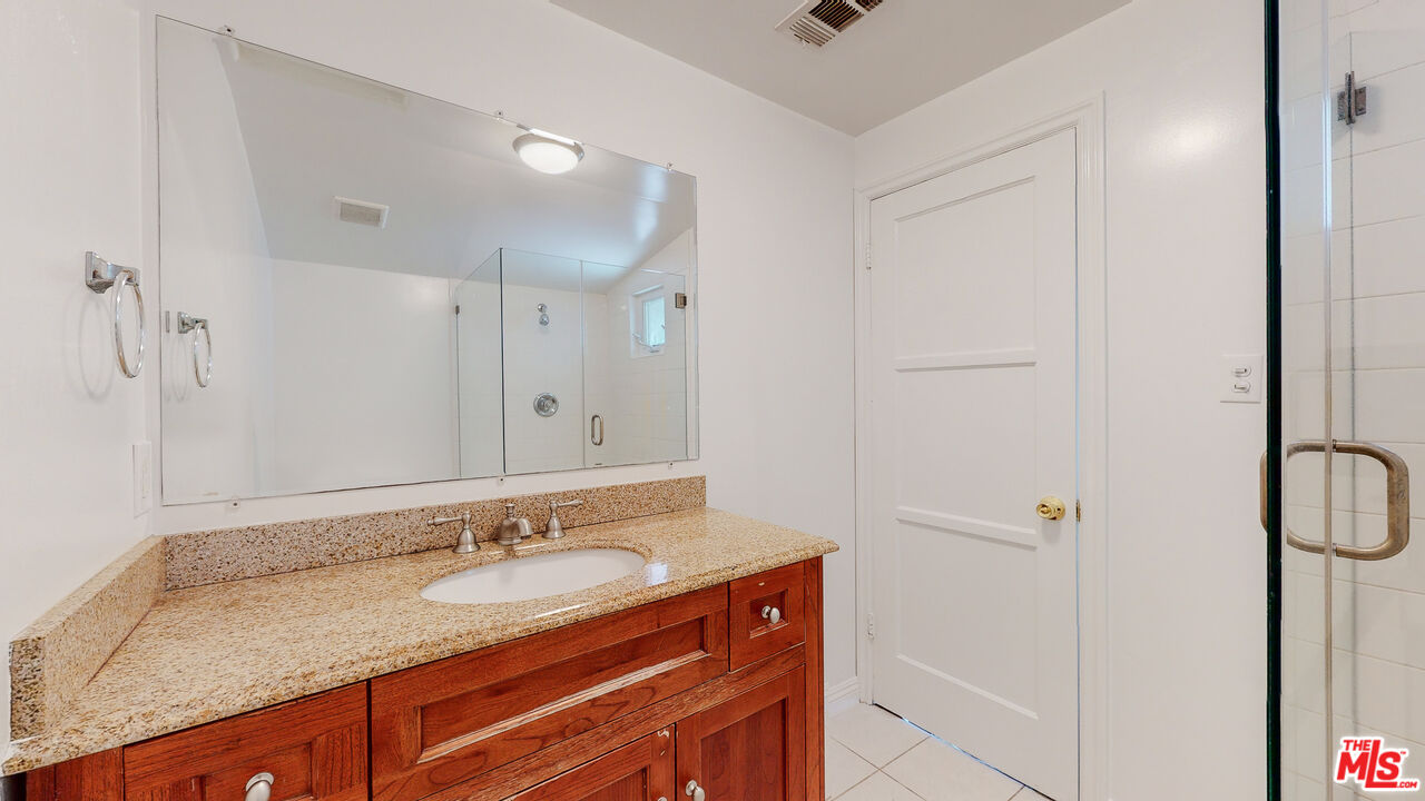 7865 Denivelle Road Sunland, CA 91040 - Photo 30 of 54 a bathroom with a granite countertop sink and a mirror