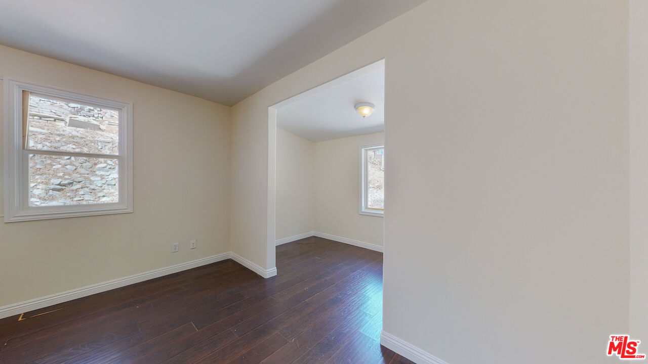 7865 Denivelle Road Sunland, CA 91040 - Photo 31 of 54 an empty room with wooden floor and windows