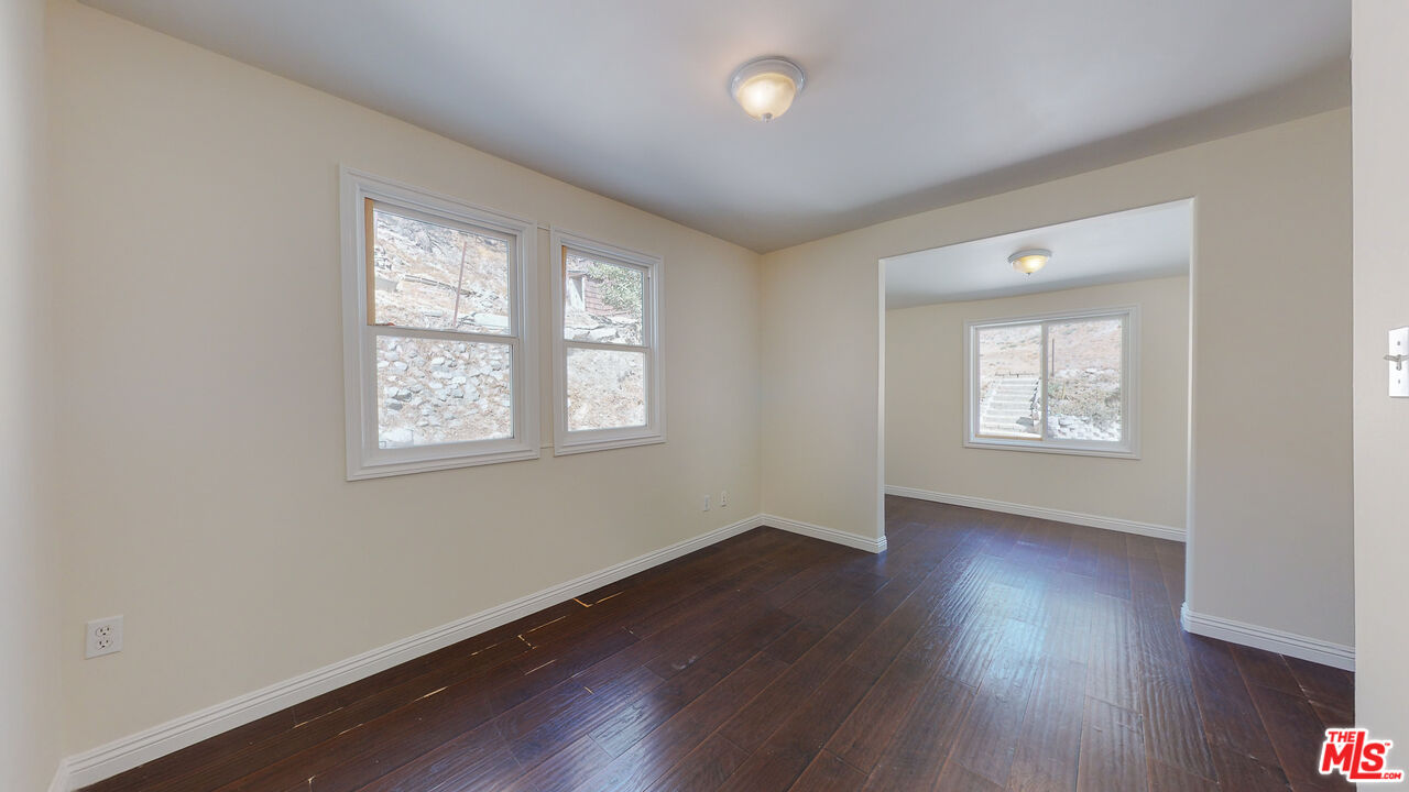 7865 Denivelle Road Sunland, CA 91040 - Photo 32 of 54 an empty room with wooden floor and windows