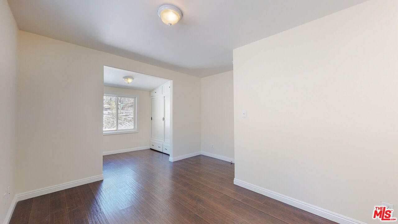 7865 Denivelle Road Sunland, CA 91040 - Photo 33 of 54 a view of an empty room with wooden floor and a window