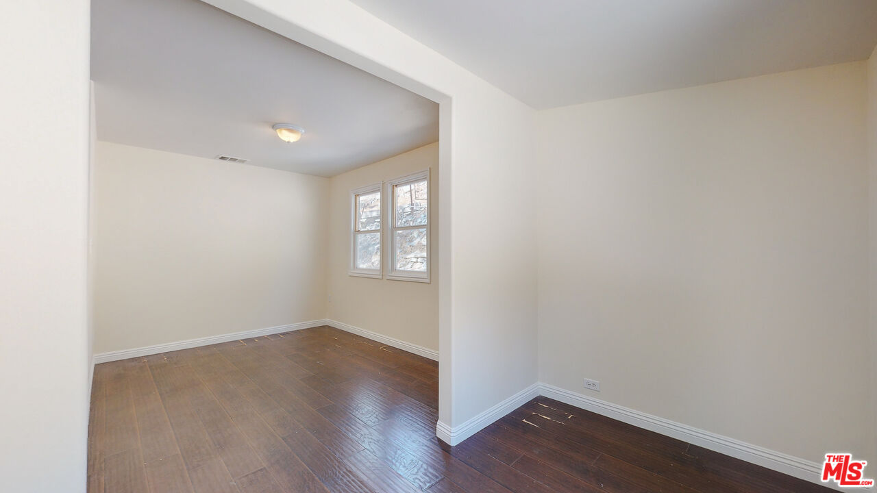7865 Denivelle Road Sunland, CA 91040 - Photo 34 of 54 an empty room with wooden floor and windows