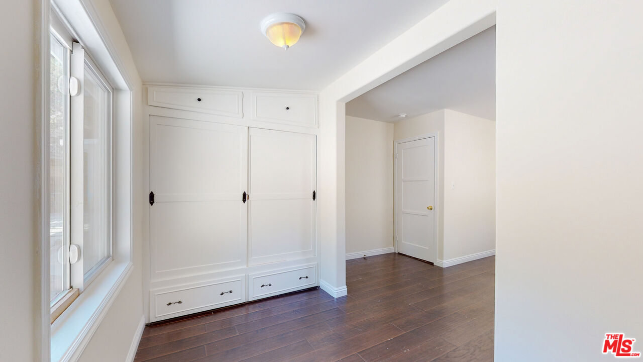 7865 Denivelle Road Sunland, CA 91040 - Photo 35 of 54 a view of an empty room with wooden floor and a window